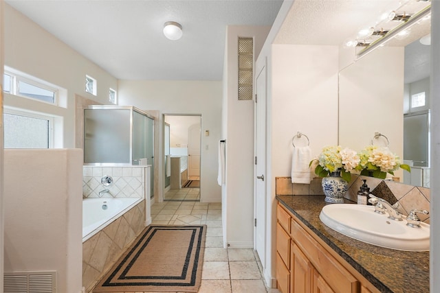 1810 Eucalyptus Rd NE, Rio Rancho, NM 87144 - bathroom with a shower stall, vanity, a garden tub, tile patterned flooring, and baseboards
