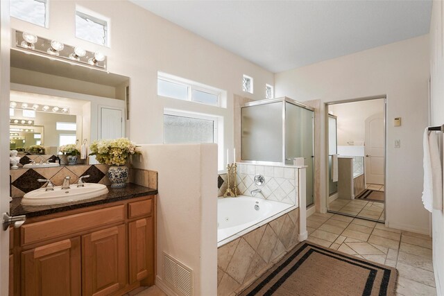 1810 Eucalyptus Rd NE, Rio Rancho, NM 87144 - bathroom featuring a shower stall, vanity, a tub with jets, tile patterned floors, and tasteful backsplash