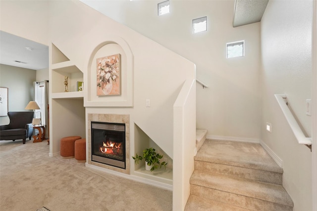 1810 Eucalyptus Rd NE, Rio Rancho, NM 87144 - stairway with carpet floors, a high ceiling, a fireplace, and baseboards