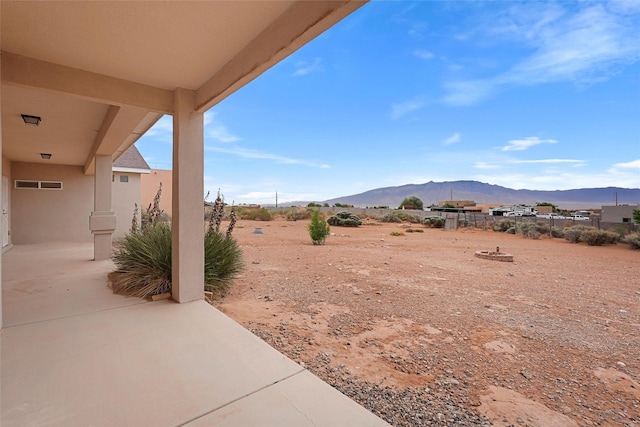 1810 Eucalyptus Rd NE, Rio Rancho, NM 87144 - view of yard with a mountain view and a patio area