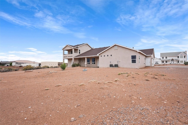 1810 Eucalyptus Rd NE, Rio Rancho, NM 87144 - back of house featuring stucco siding and central AC