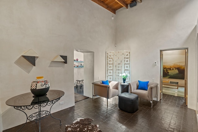 519 E Palace Ave, Santa Fe, NM 87501 - living area with brick floors, high vaulted ceiling, and wood ceiling with exposed beams