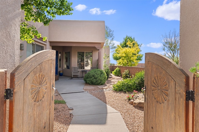 1 Pajarito Peak, Santa Fe, NM 87508 - property entrance with a gate and stucco siding