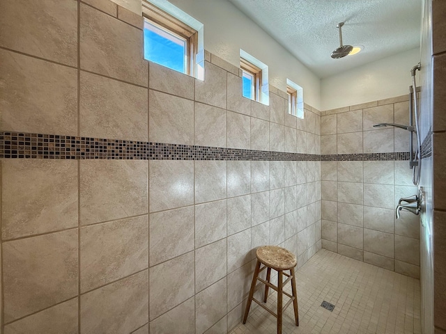 9 Camino Maravilla, Santa Fe, NM 87506 - bathroom with a tile shower and a textured ceiling