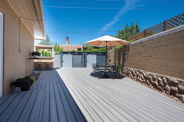 202 Alamo Dr, Santa Fe, NM 87501 - wooden deck with outdoor dining area and an outdoor kitchen