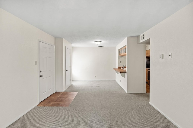 941 Calle Mejia Unit 1610, Santa Fe, NM 87501 - empty room featuring carpet, baseboards, and a sink