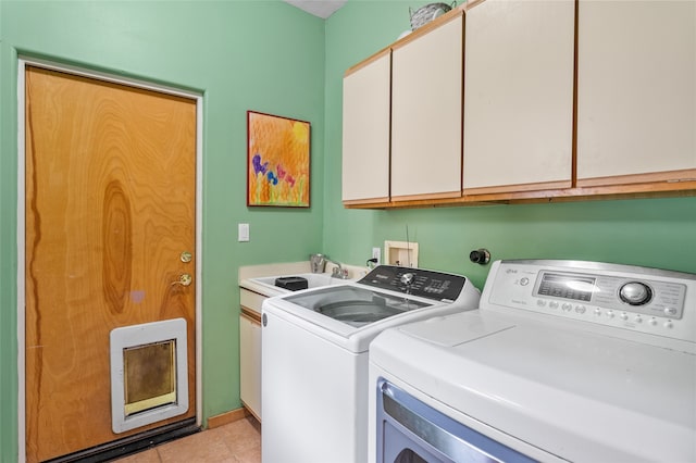 65 E Sombrillo Rd, Nm, NM 87532 - washroom featuring washing machine and clothes dryer, cabinet space, light tile patterned flooring, and heating unit