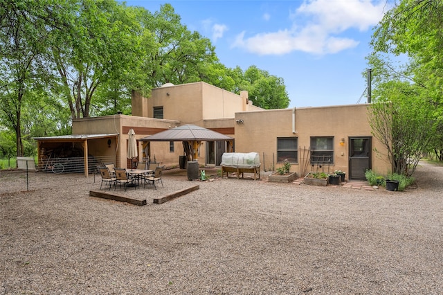 65 E Sombrillo Rd, Nm, NM 87532 - rear view of property featuring stucco siding, a patio area, and a gazebo