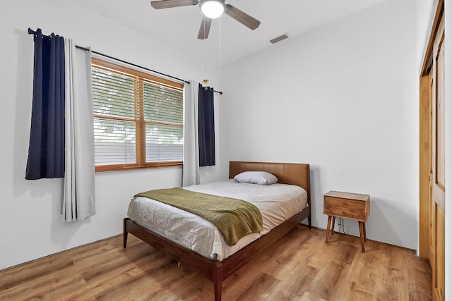 138 E Chili Line, Santa Fe, NM 87508 - bedroom featuring light wood finished floors and a ceiling fan