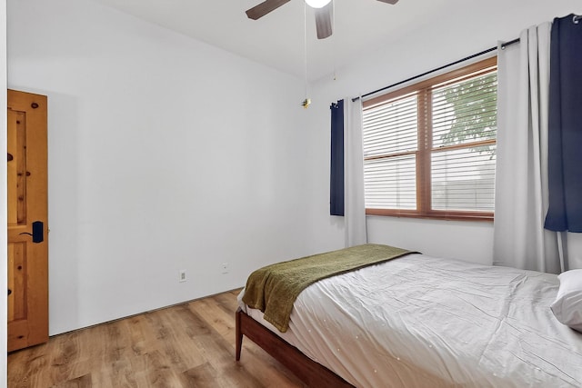 138 E Chili Line, Santa Fe, NM 87508 - bedroom with wood finished floors and a ceiling fan