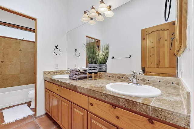 138 E Chili Line, Santa Fe, NM 87508 - full bath with double vanity, toilet, tile patterned flooring, bathtub / shower combination, and a chandelier