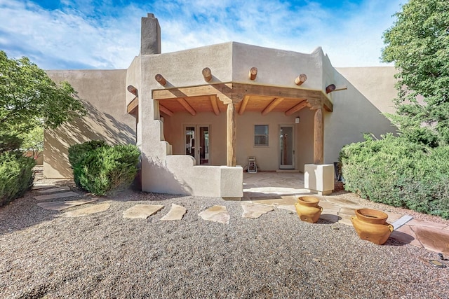138 E Chili Line, Santa Fe, NM 87508 - back of house featuring a patio area, a chimney, and french doors