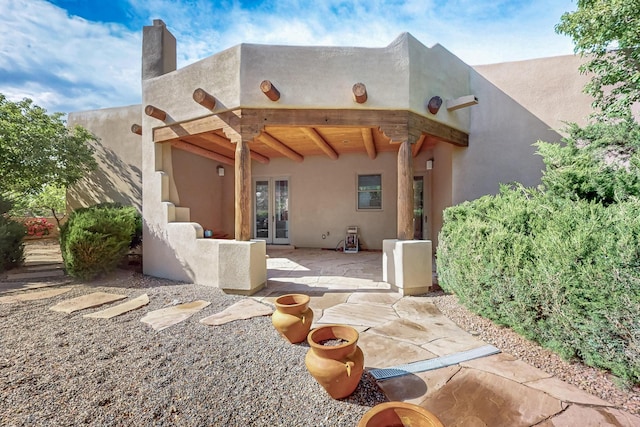 138 E Chili Line, Santa Fe, NM 87508 - rear view of property with french doors, a patio area, and stucco siding