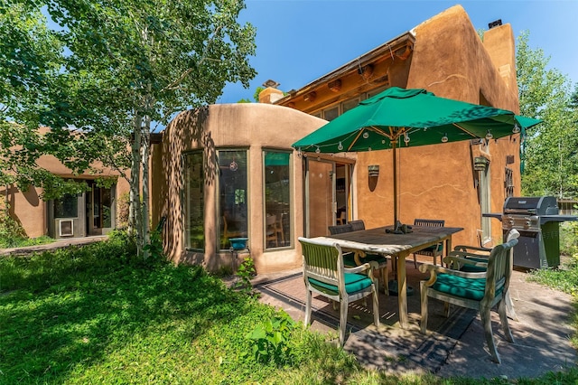 525 Camino Militar, Santa Fe, NM 87501 - rear view of property featuring a chimney, stucco siding, and outdoor dining space