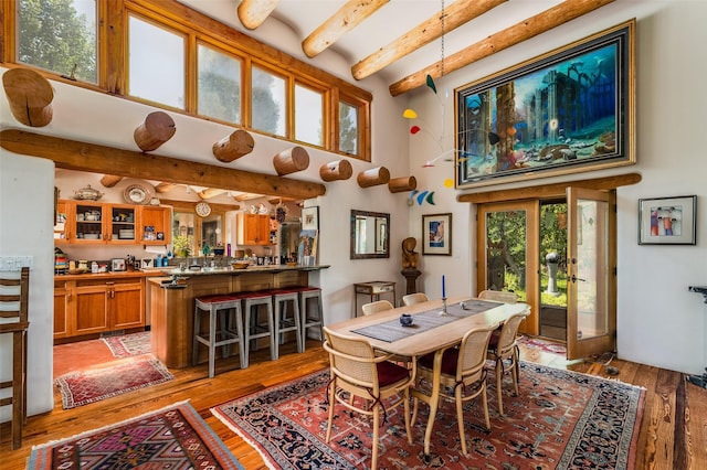 525 Camino Militar, Santa Fe, NM 87501 - dining area featuring beamed ceiling, light wood-style flooring, and a high ceiling