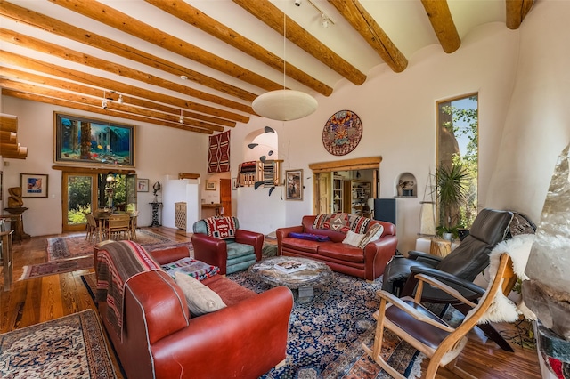525 Camino Militar, Santa Fe, NM 87501 - living room featuring beam ceiling, wood finished floors, plenty of natural light, and a towering ceiling