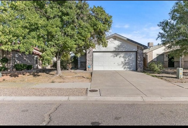 1128 Pandora Dr SW, Los Lunas, NM 87031 - view of front of home featuring a garage and concrete driveway