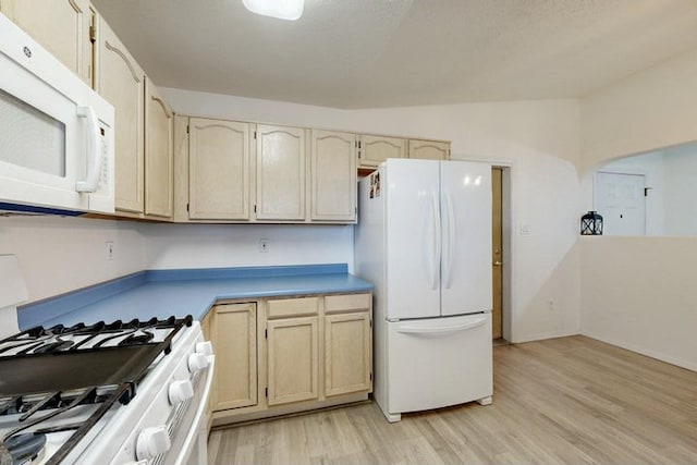 1128 Pandora Dr SW, Los Lunas, NM 87031 - kitchen with white appliances, light wood-style floors, and light countertops