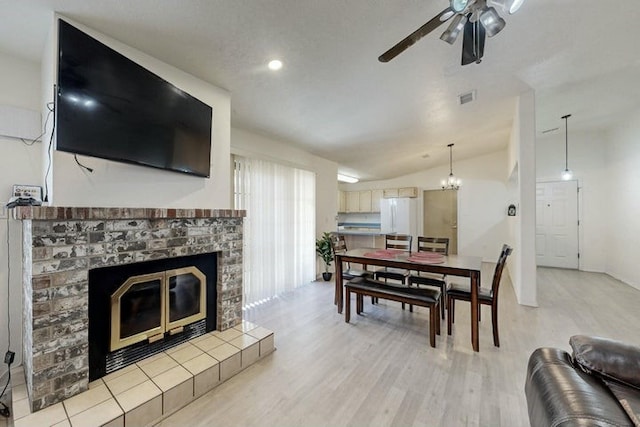 1128 Pandora Dr SW, Los Lunas, NM 87031 - living room with a glass covered fireplace, lofted ceiling, a ceiling fan, light wood-type flooring, and recessed lighting