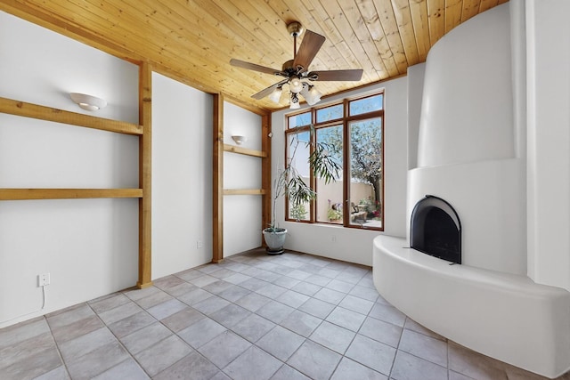 3260 La Paz, Santa Fe, NM 87507 - unfurnished living room featuring wood ceiling, a ceiling fan, and light tile patterned floors