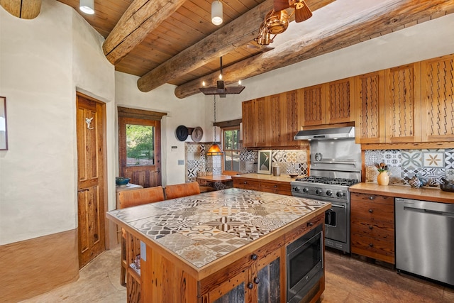 26 Camino Los Angelitos, Santa Fe, NM 87540 - kitchen featuring stainless steel appliances, under cabinet range hood, wood ceiling with exposed beams, tile counters, and backsplash