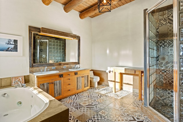 26 Camino Los Angelitos, Santa Fe, NM 87540 - full bath with wood ceiling with exposed beams, a shower stall, a whirlpool tub, double vanity, and toilet