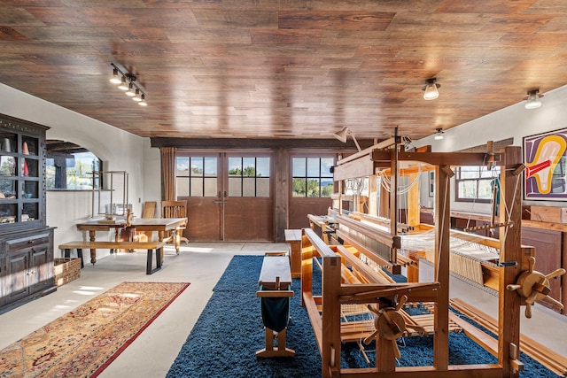 26 Camino Los Angelitos, Santa Fe, NM 87540 - living room featuring wooden ceiling, plenty of natural light, finished concrete floors, and french doors