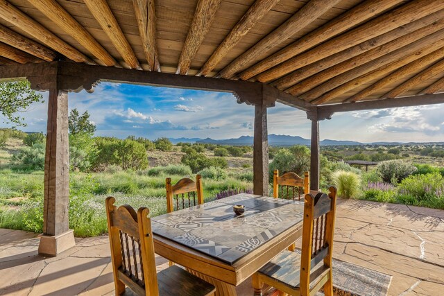 26 Camino Los Angelitos, Santa Fe, NM 87540 - view of patio / terrace featuring a mountain view and outdoor dining space