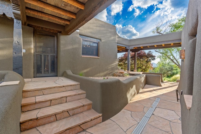 26 Camino Los Angelitos, Santa Fe, NM 87540 - doorway to property featuring a patio area