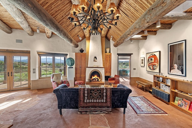 26 Camino Los Angelitos, Santa Fe, NM 87540 - living room with wood ceiling with exposed beams, a high ceiling, a chandelier, french doors, and a large fireplace