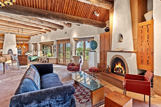 26 Camino Los Angelitos, Santa Fe, NM 87540 - living area featuring wood ceiling with exposed beams, a large fireplace, and a high ceiling