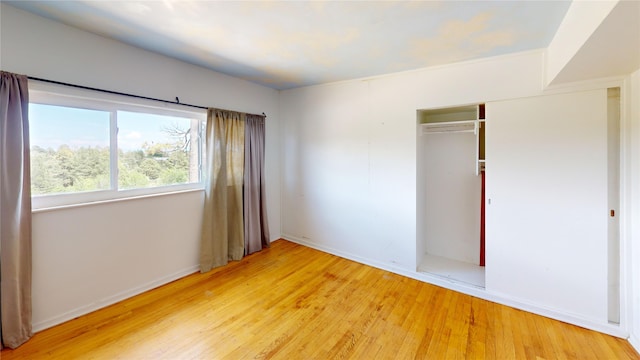 4030 Urban Unit C, Los Alamos, NM 87544 - unfurnished bedroom featuring wood finished floors, a closet, and baseboards