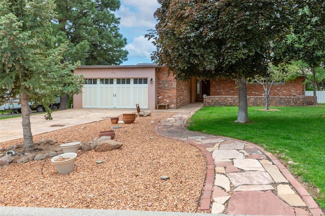 215 San Juan St, Los Alamos, NM 87544 - view of front of home featuring brick siding, an attached garage, a front lawn, and driveway