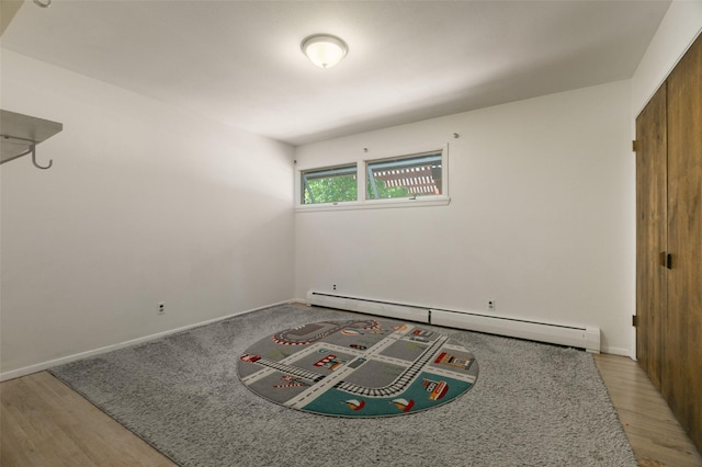 215 San Juan St, Los Alamos, NM 87544 - unfurnished bedroom with a baseboard radiator, light wood-style floors, and baseboards