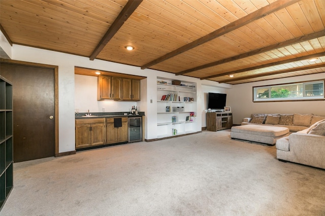 215 San Juan St, Los Alamos, NM 87544 - living area with wet bar, beverage cooler, light colored carpet, built in shelves, and wooden ceiling with exposed beams