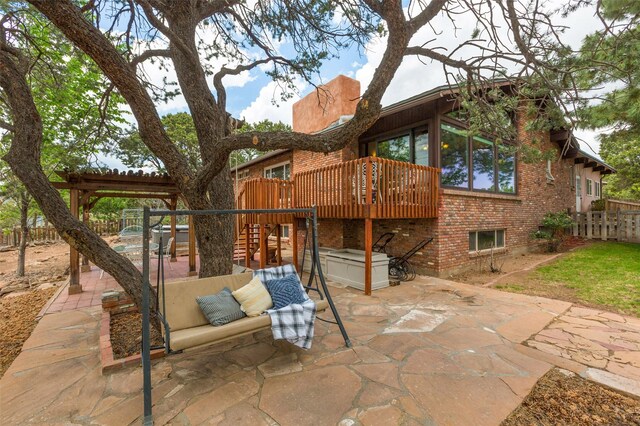 215 San Juan St, Los Alamos, NM 87544 - back of property featuring a patio area, brick siding, a jacuzzi, a wooden deck, and stairs