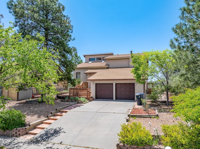 1327 San Ildefonso Rd, Los Alamos, NM 87544 - view of front facade featuring stucco siding, concrete driveway, a shingled roof, and a garage