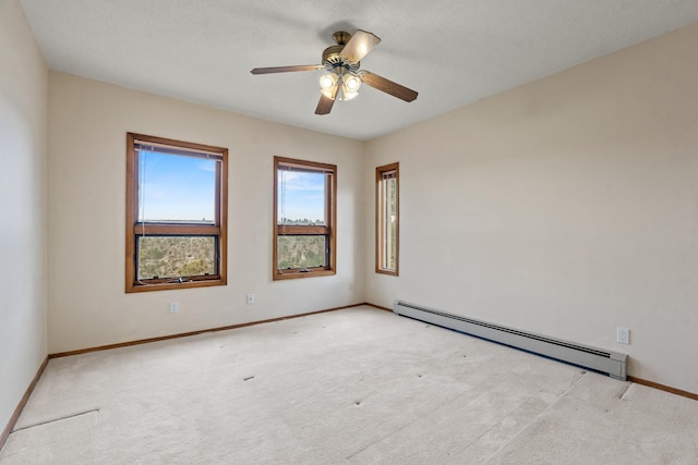 1327 San Ildefonso Rd, Los Alamos, NM 87544 - carpeted spare room featuring a baseboard heating unit, baseboards, and a ceiling fan