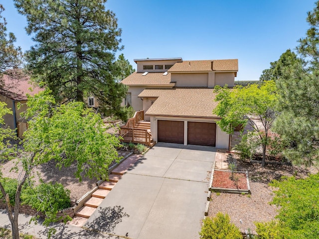 1327 San Ildefonso Rd, Los Alamos, NM 87544 - view of front of house featuring stucco siding, concrete driveway, stairs, roof with shingles, and a garage