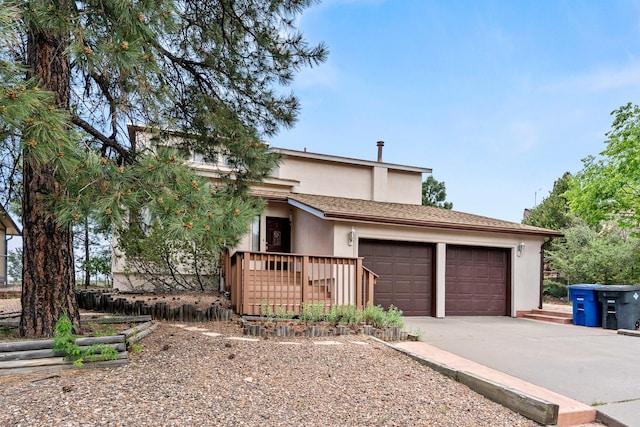 1327 San Ildefonso Rd, Los Alamos, NM 87544 - view of front of house featuring concrete driveway, an attached garage, and stucco siding
