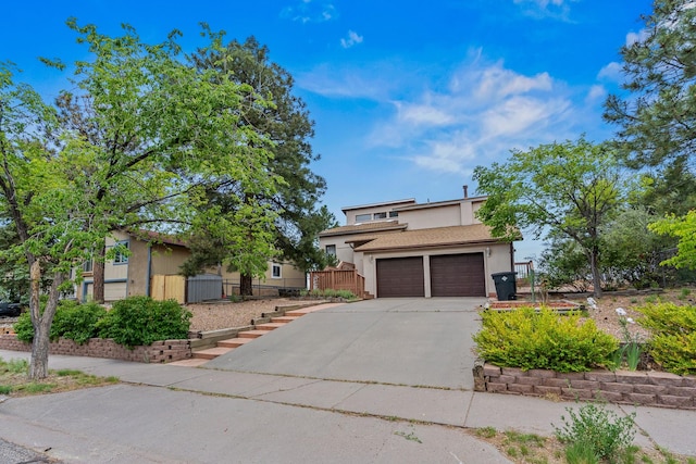 1327 San Ildefonso Rd, Los Alamos, NM 87544 - view of front facade featuring stucco siding, driveway, and an attached garage