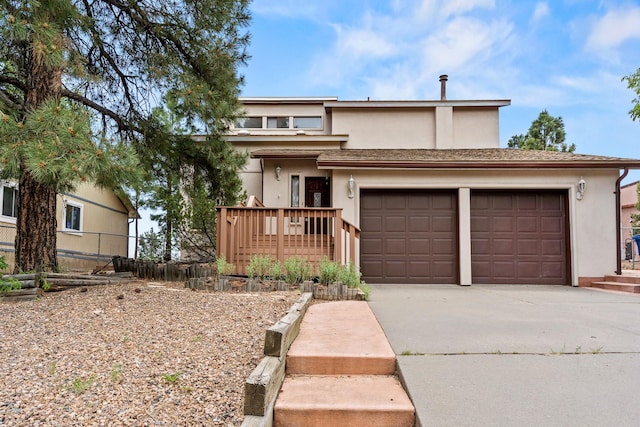 1327 San Ildefonso Rd, Los Alamos, NM 87544 - view of front of property featuring stucco siding, concrete driveway, and a garage