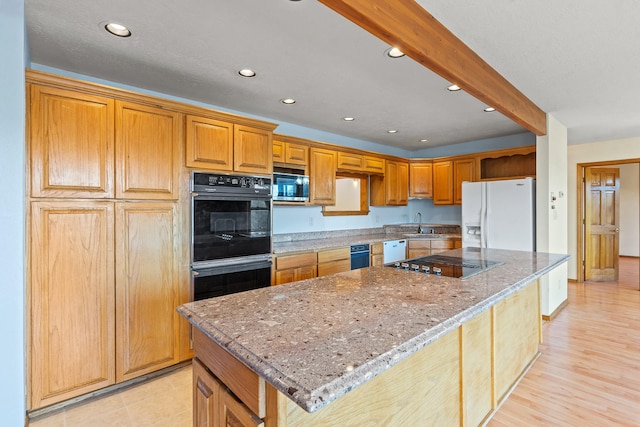 1327 San Ildefonso Rd, Los Alamos, NM 87544 - kitchen with black appliances, recessed lighting, light stone countertops, and a kitchen island