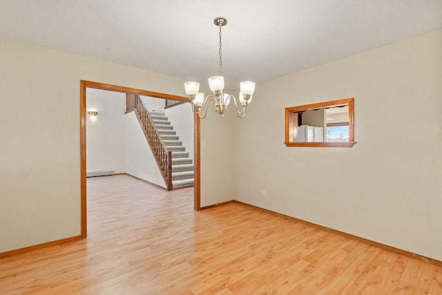 1327 San Ildefonso Rd, Los Alamos, NM 87544 - spare room featuring stairway, light wood-type flooring, a chandelier, and baseboards