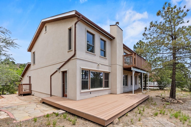 1327 San Ildefonso Rd, Los Alamos, NM 87544 - rear view of house featuring a patio, a chimney, stucco siding, and a wooden deck