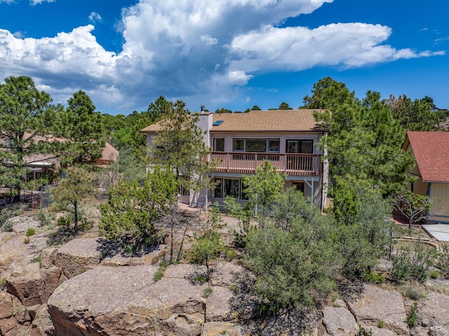 1327 San Ildefonso Rd, Los Alamos, NM 87544 - rear view of house featuring a wooden deck, a chimney, and a shingled roof