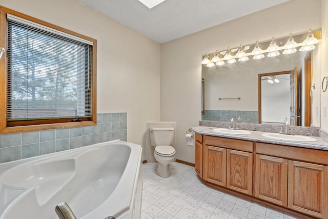 1327 San Ildefonso Rd, Los Alamos, NM 87544 - full bath with double vanity, a garden tub, toilet, baseboards, and tile patterned floors
