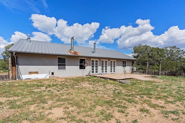 71 Apache Plume Dr, Santa Fe, NM 87508 - back of house featuring french doors, stucco siding, a patio area, and metal roof