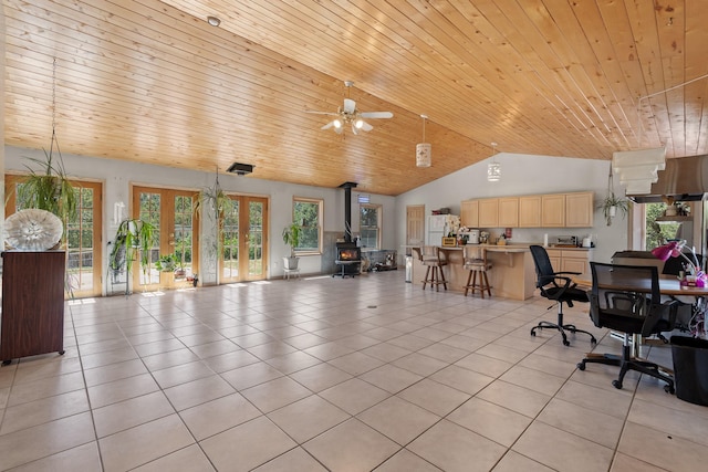 71 Apache Plume Dr, Santa Fe, NM 87508 - office area with lofted ceiling, light tile patterned floors, wooden ceiling, a wood stove, and plenty of natural light