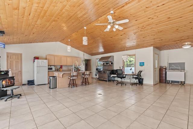 71 Apache Plume Dr, Santa Fe, NM 87508 - living area with light tile patterned floors, vaulted ceiling, a wood stove, ceiling fan, and wooden ceiling